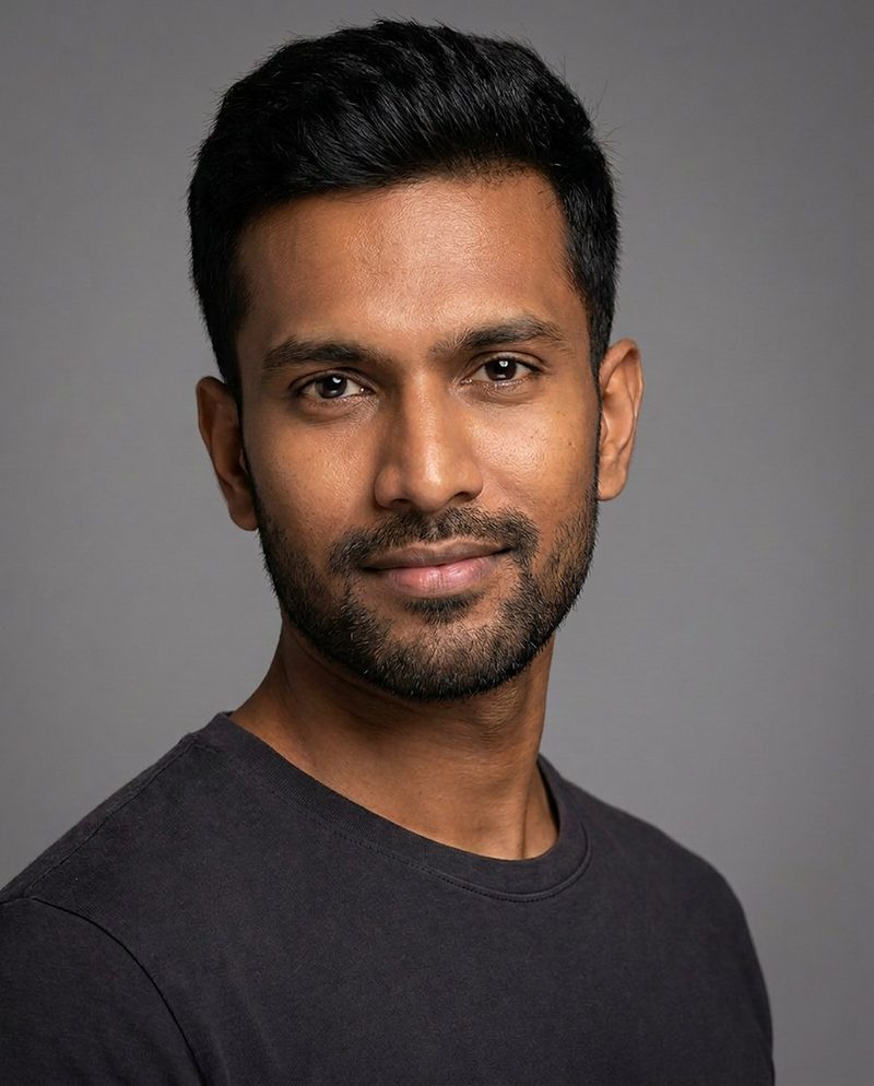 Dev, AI-generated model: smiling headshot