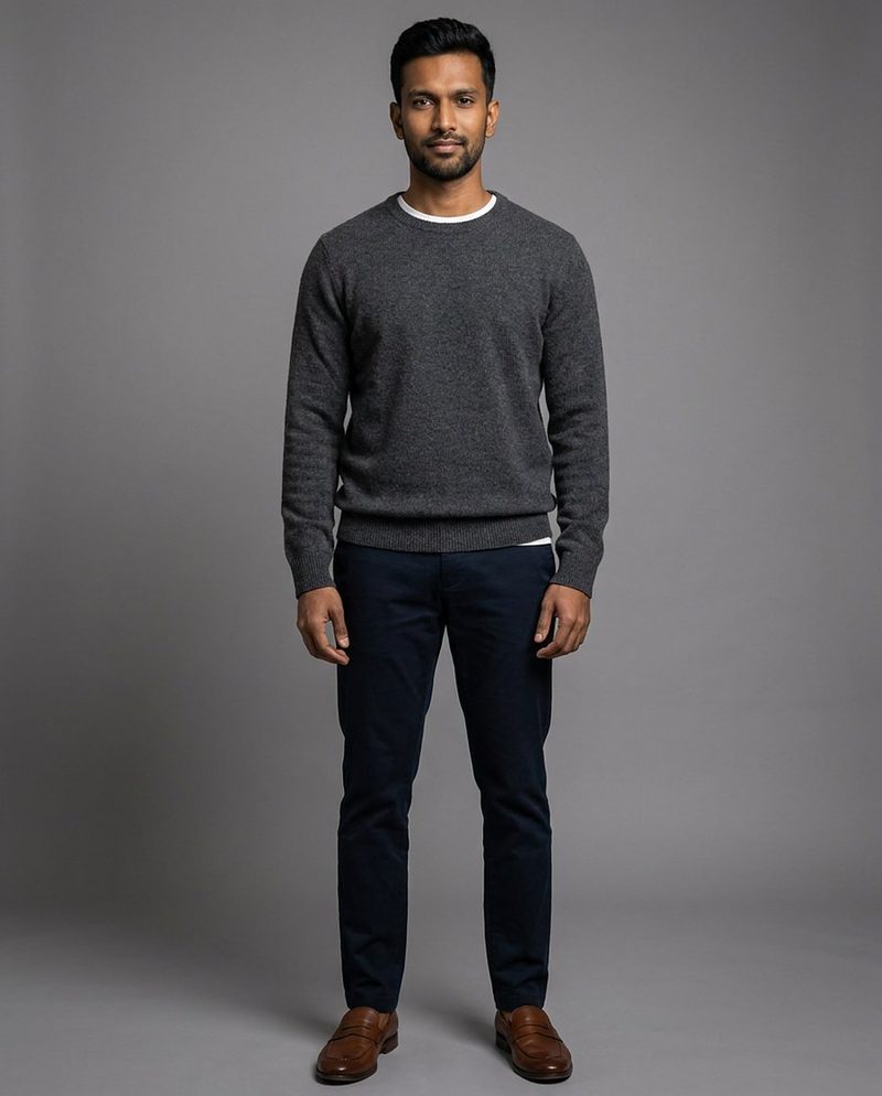 Dev, AI-generated model: full-length in a grey sweater and navy trousers