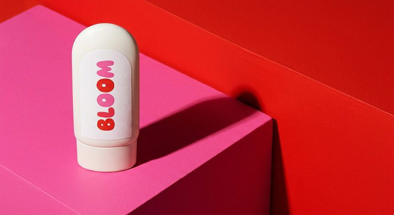 White squeeze tube standing on stacked pink and red blocks